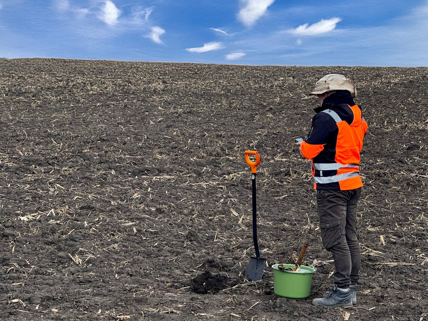 Manual soil sampling in a tilled field using a spade and bucket